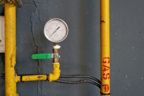 gas-line-repair-gas-pipes-gauge-on-wall-valve